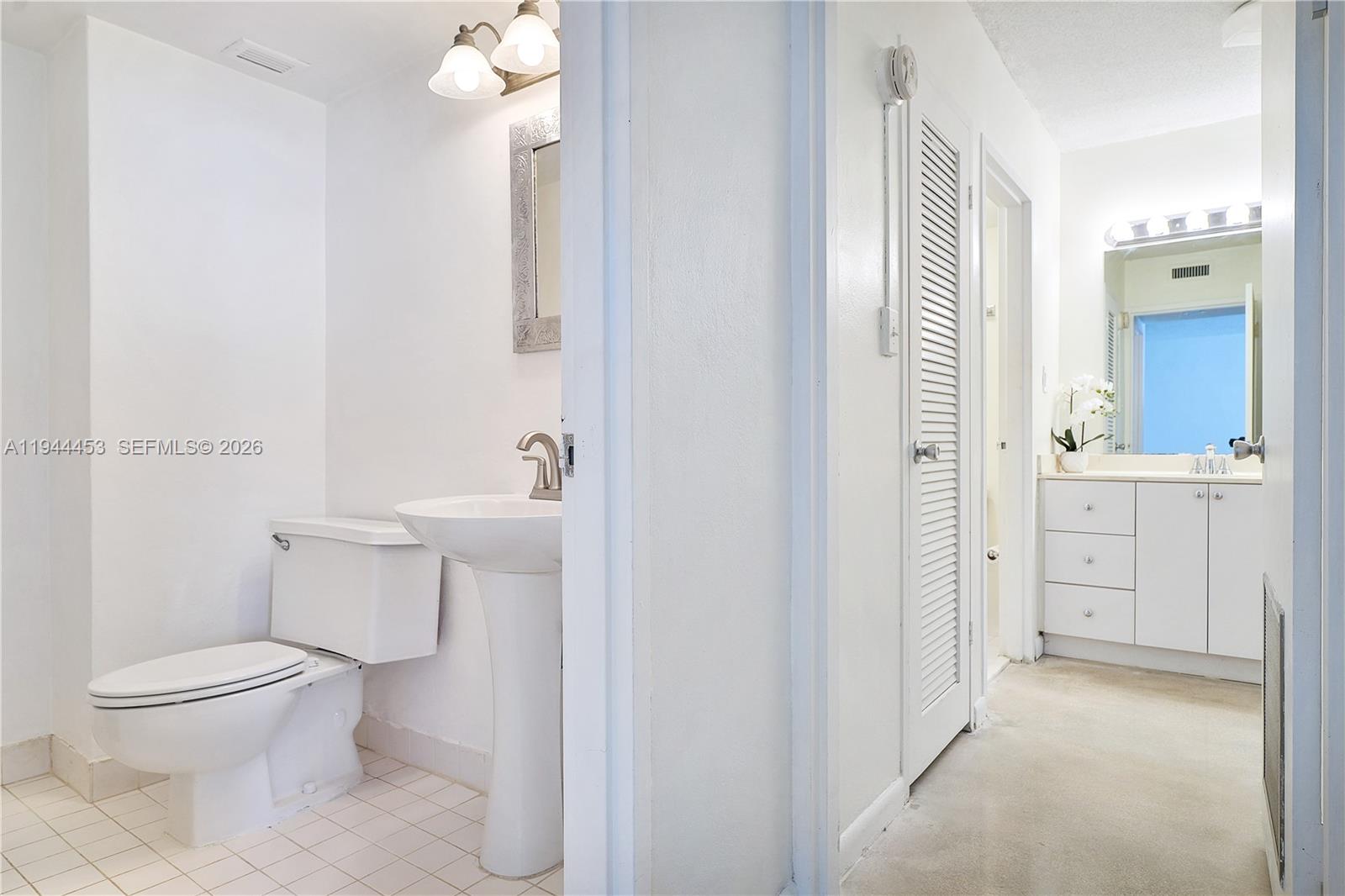 9225 Collins Avenue, Unit 705 Surfside, FL 33154 - Photo 11 of 17 a bathroom with a toilet a sink and shower