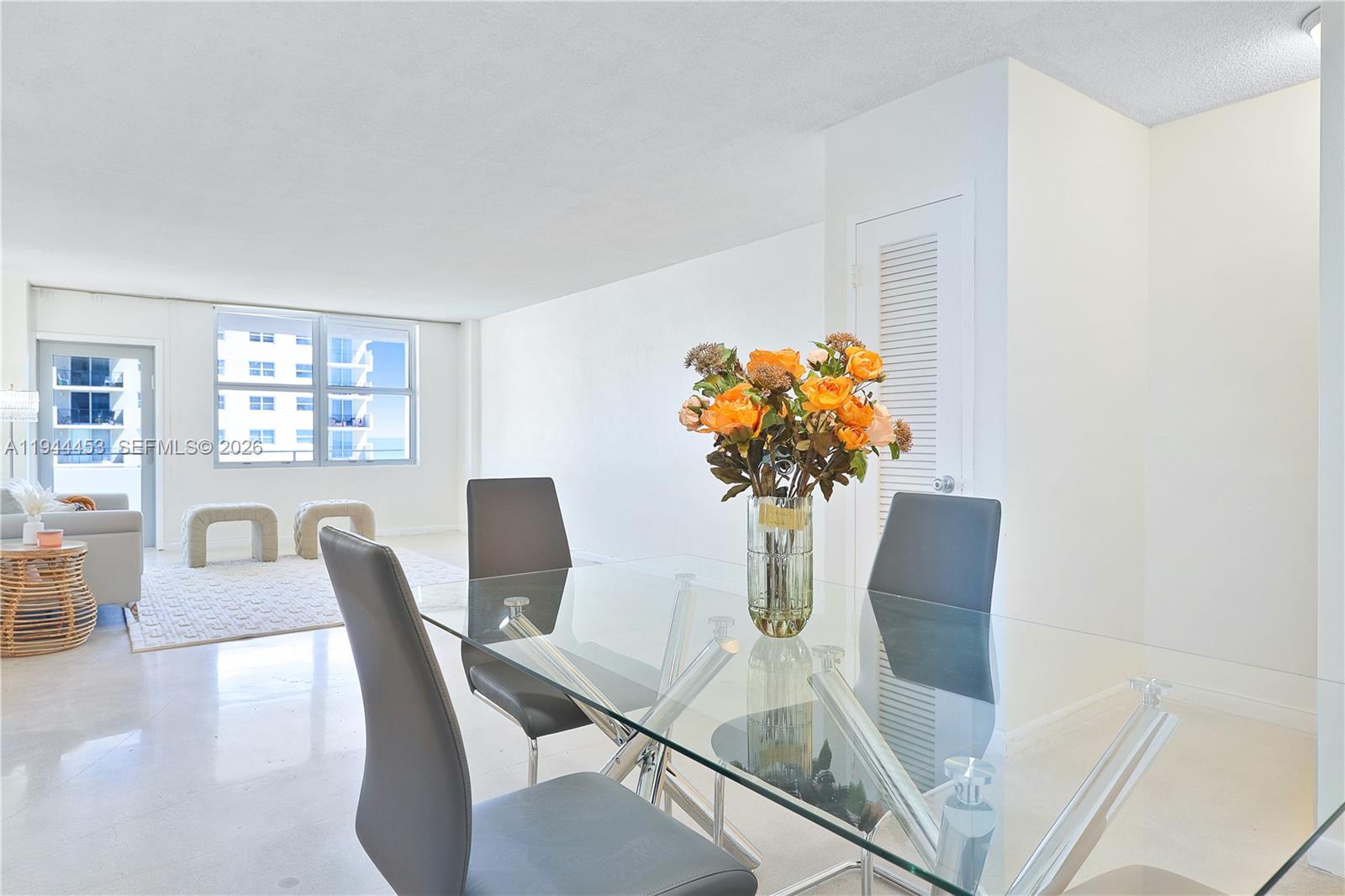9225 Collins Avenue, Unit 705 Surfside, FL 33154 - Photo 12 of 17 a view of a dining room with furniture and a potted plant