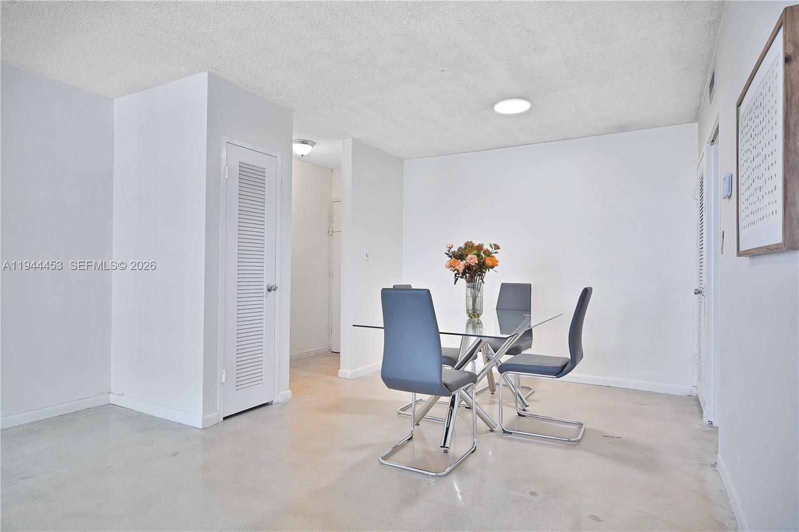 9225 Collins Avenue, Unit 705 Surfside, FL 33154 - Photo 6 of 17 a workspace with furniture and a potted plant