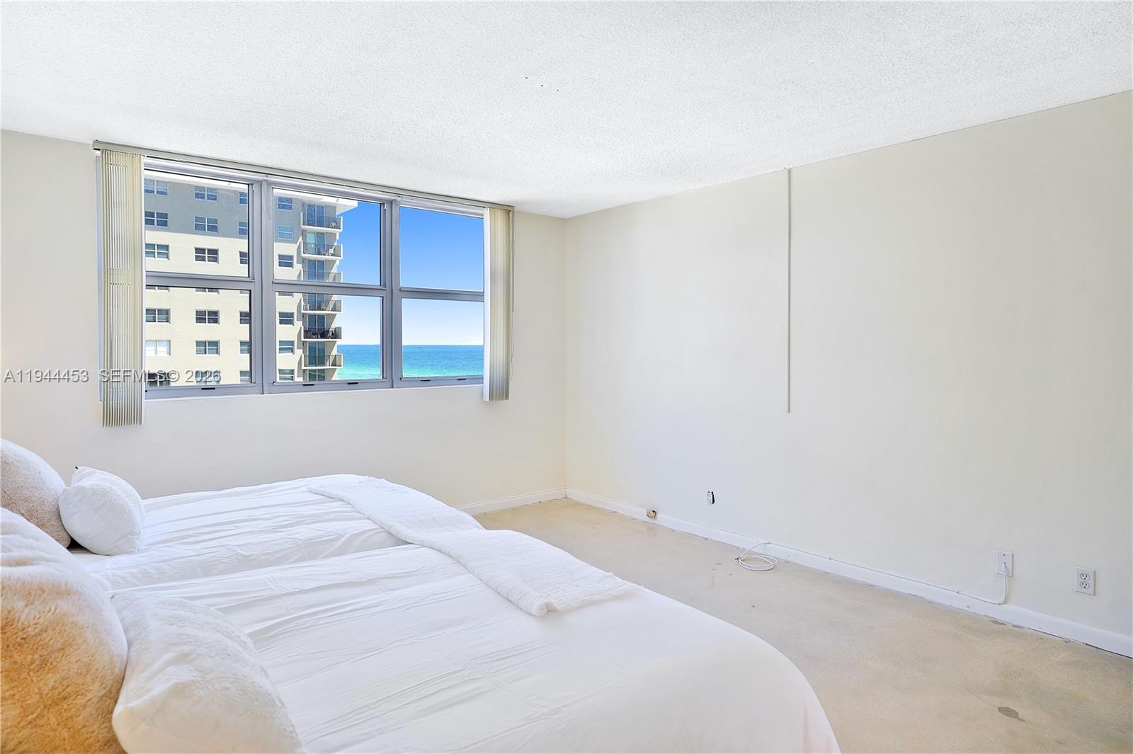 9225 Collins Avenue, Unit 705 Surfside, FL 33154 - Photo 7 of 17 a bedroom with a large bed and a window