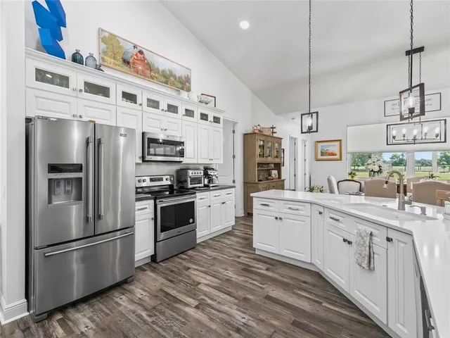a kitchen with stainless steel appliances a refrigerator sink and cabinets