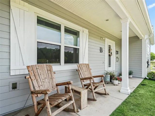a view of two chairs in the patio