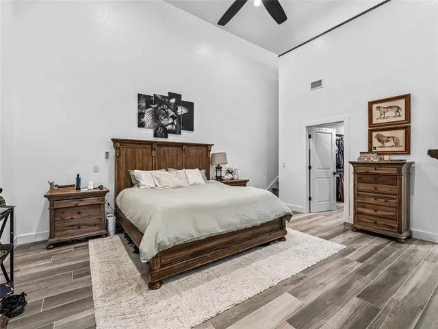 a large white kitchen with a sink and stainless steel appliances