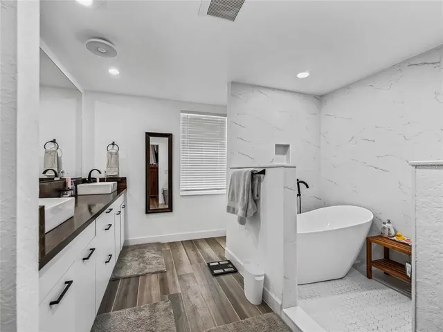 a white bath tub sitting in a bathroom