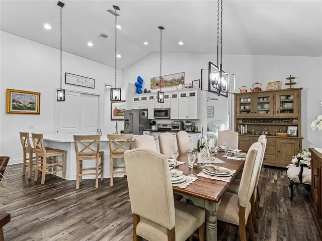 a view of a dining room with furniture wooden floor and chandelier