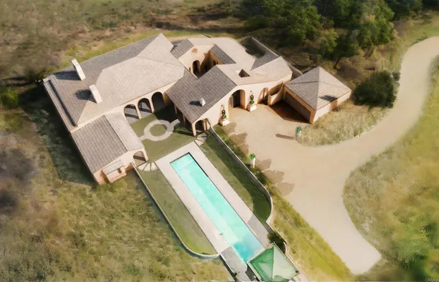 an aerial view of a house with a swimming pool