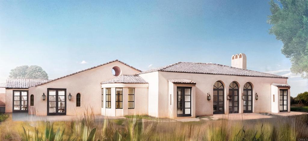 18096 Loma Alegre Rancho Santa Fe, CA 92067 - Photo 4 of 21 a front view of a house with a lots of windows and plants