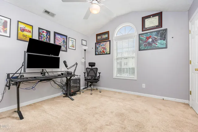 a view of a workspace with furniture and a flat screen tv