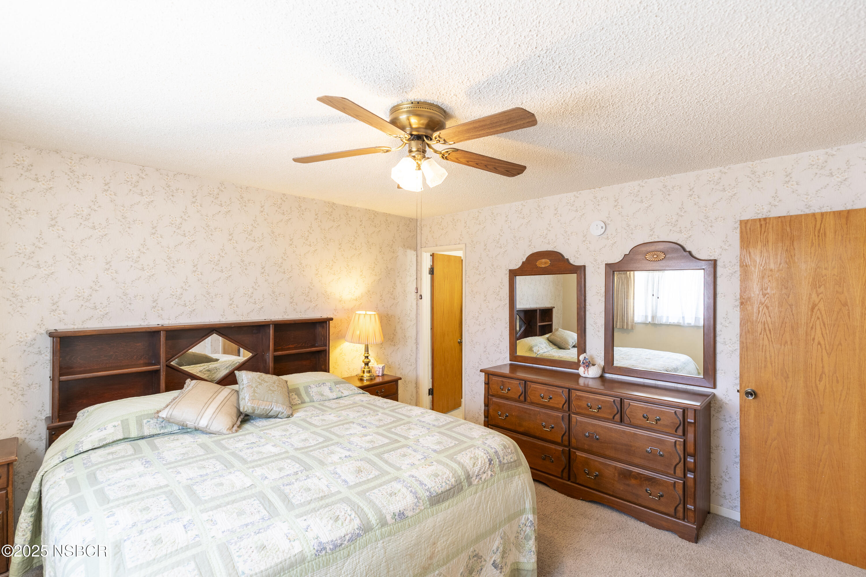 3361 Via Elba Lompoc, CA 93436 - Photo 19 of 40 a bedroom with a bed and a chandelier