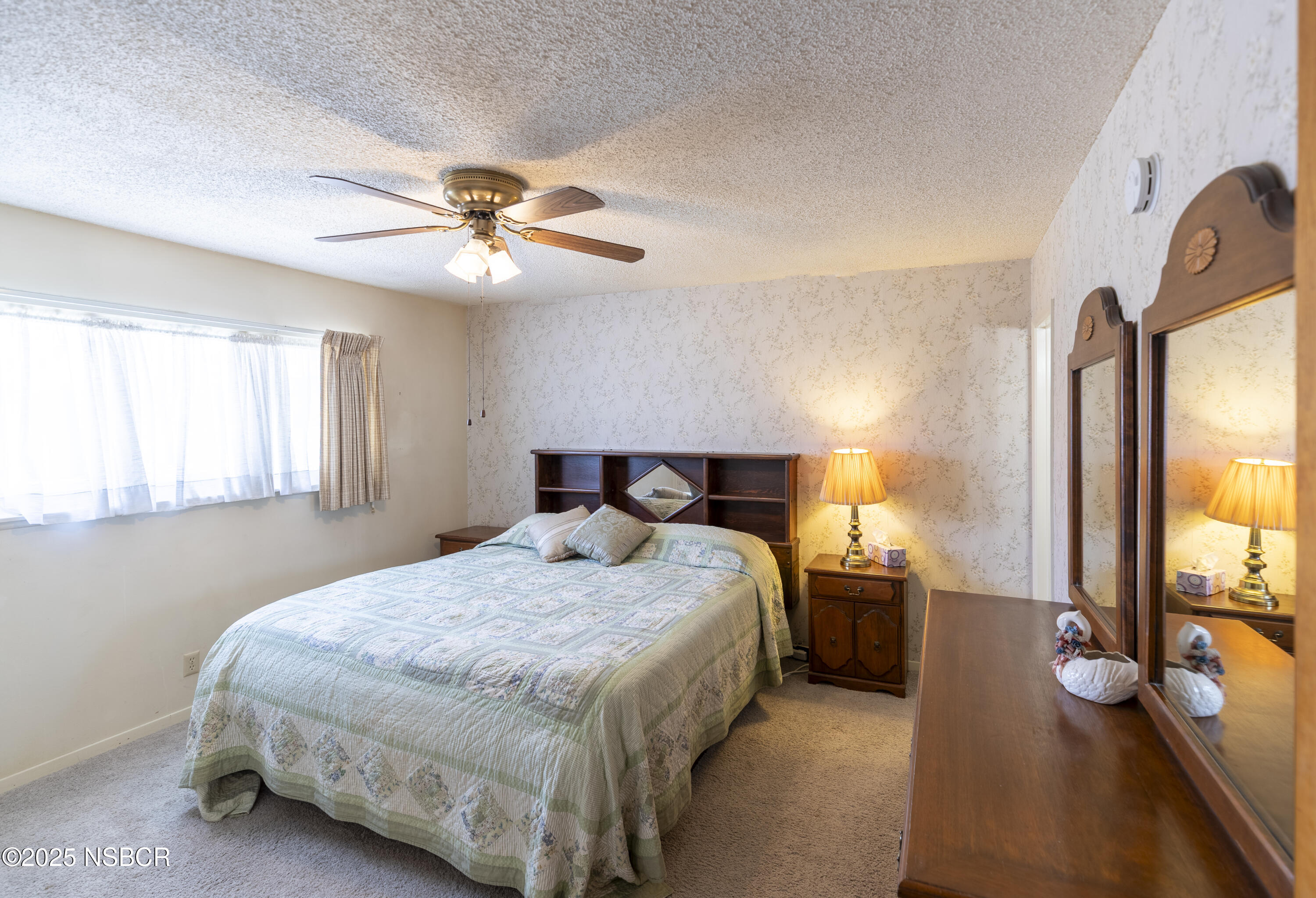 3361 Via Elba Lompoc, CA 93436 - Photo 20 of 40 a bedroom with a bed and a chandelier