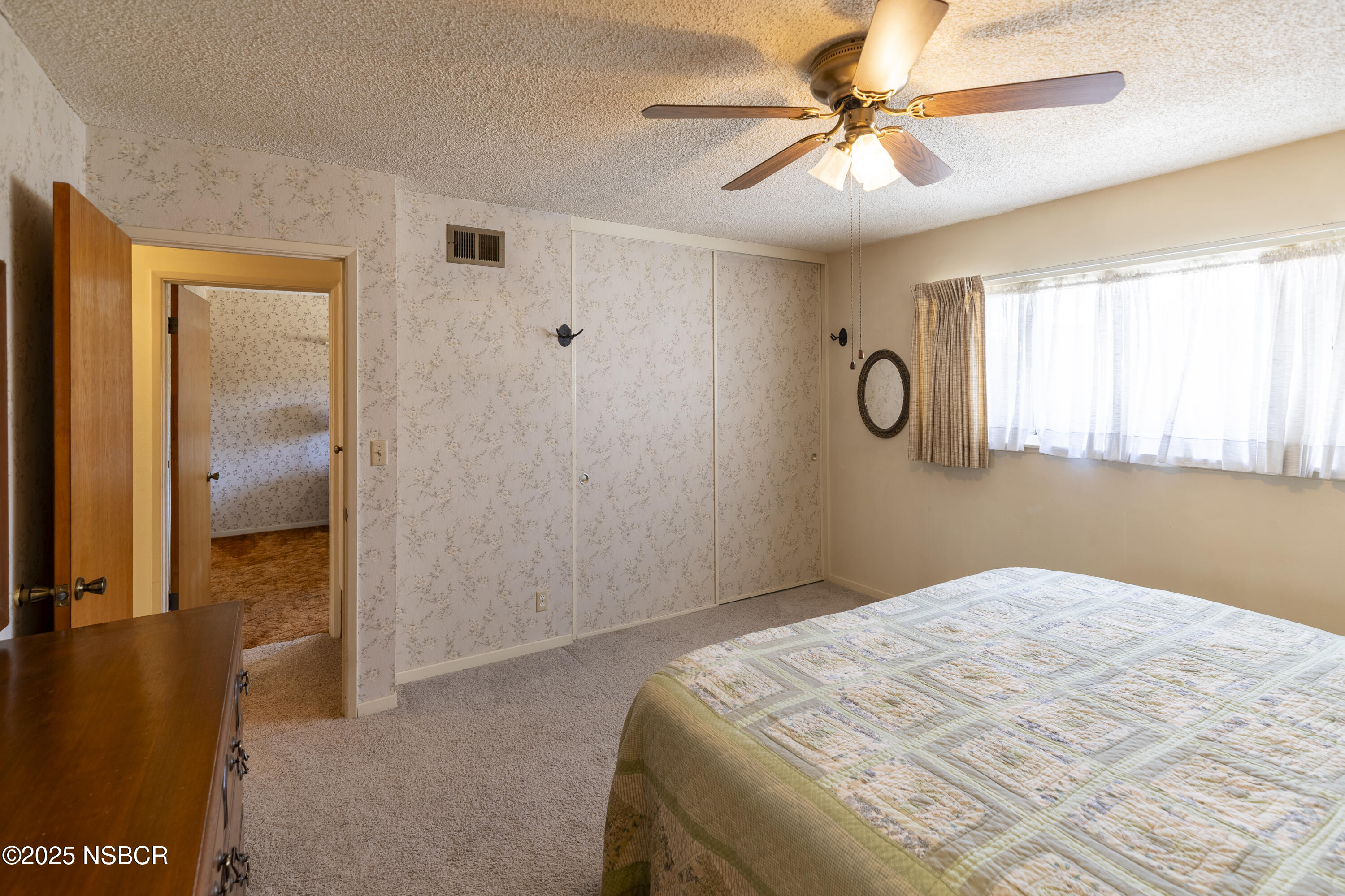 3361 Via Elba Lompoc, CA 93436 - Photo 21 of 40 a bedroom with a bed and a chandelier