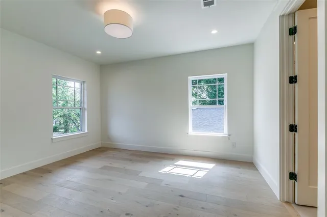 an empty room with windows and closet