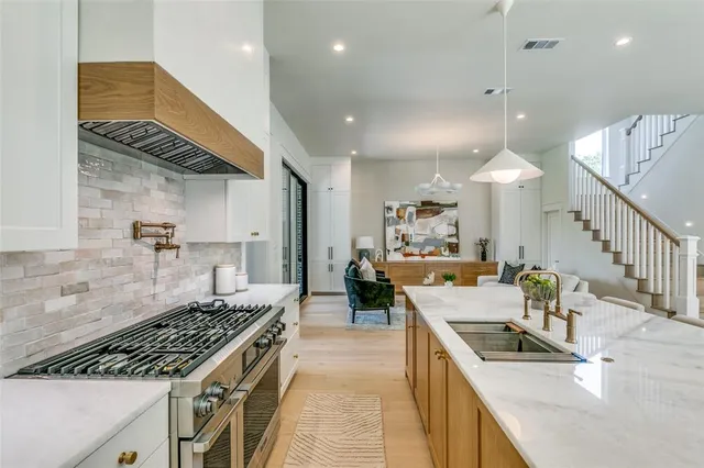 a kitchen with granite countertop a stove and a sink