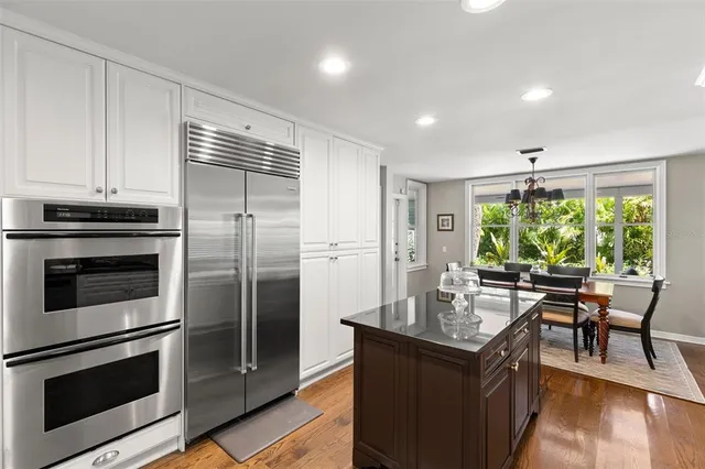 a kitchen with stainless steel appliances granite countertop a stove microwave and refrigerator