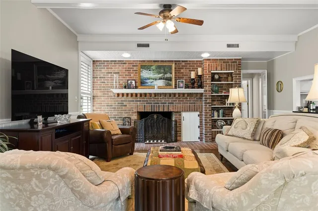 a living room with furniture fireplace and a flat screen tv
