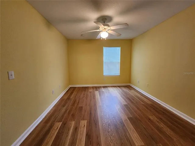 a view of room with window and wooden floor