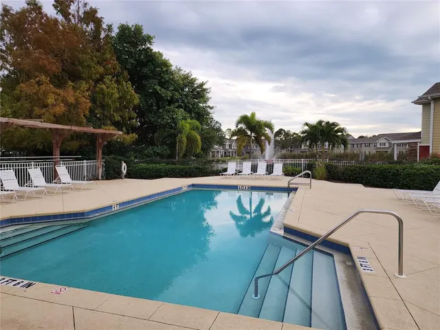 a view of a swimming pool with a yard