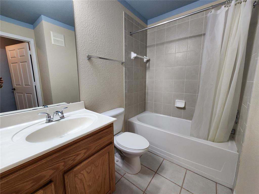 4850 51st Street West, Unit 1103 Bradenton, FL 34210 - Photo 9 of 19 a bathroom with a sink a toilet a mirror and shower