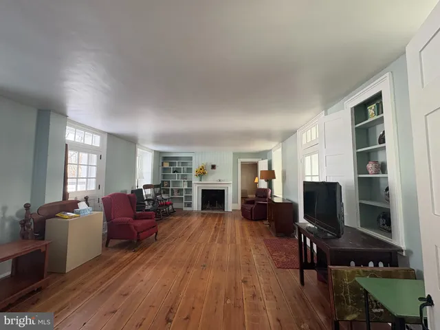 a living room with furniture flat screen tv and a fireplace