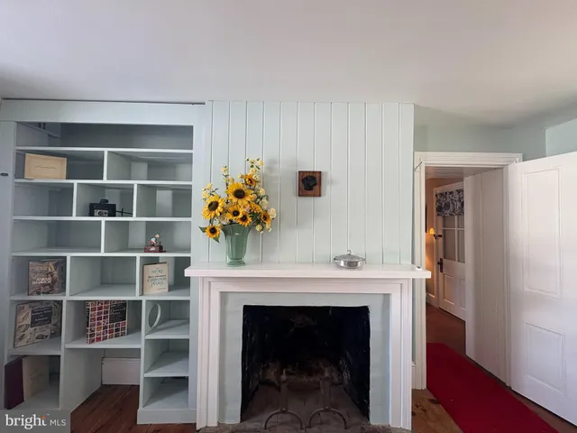 a living room with a fireplace and a wooden floor