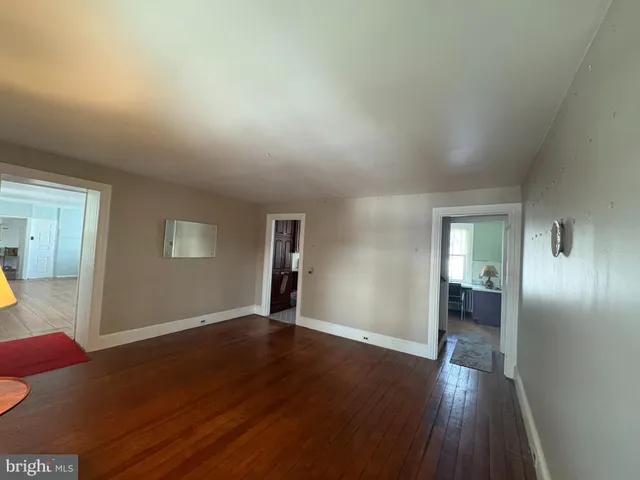 a view of an empty room and wooden floor