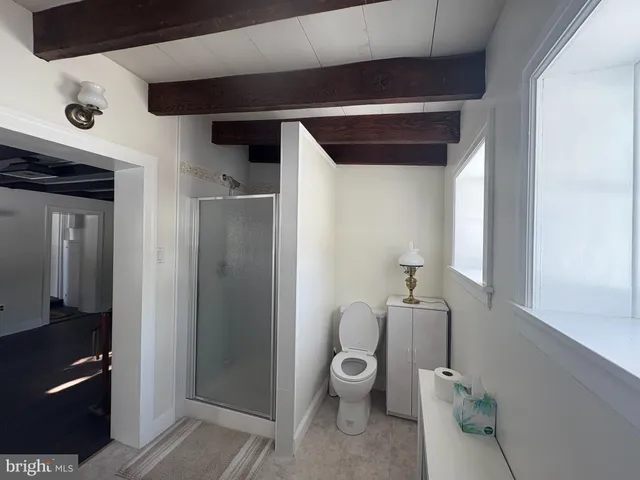 a bathroom with a toilet and a shower