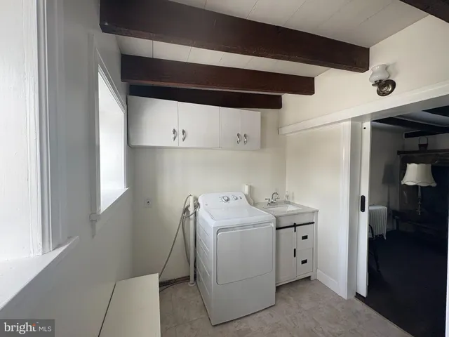 a utility room with cabinets washer and dryer