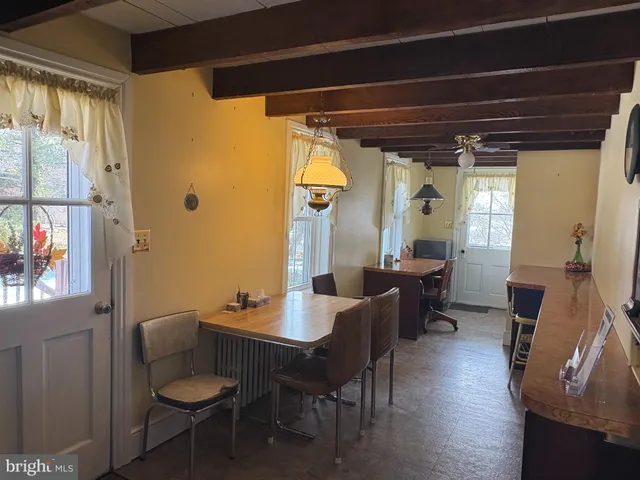 a dining room with furniture and window