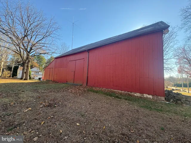 a view of a backyard with large trees
