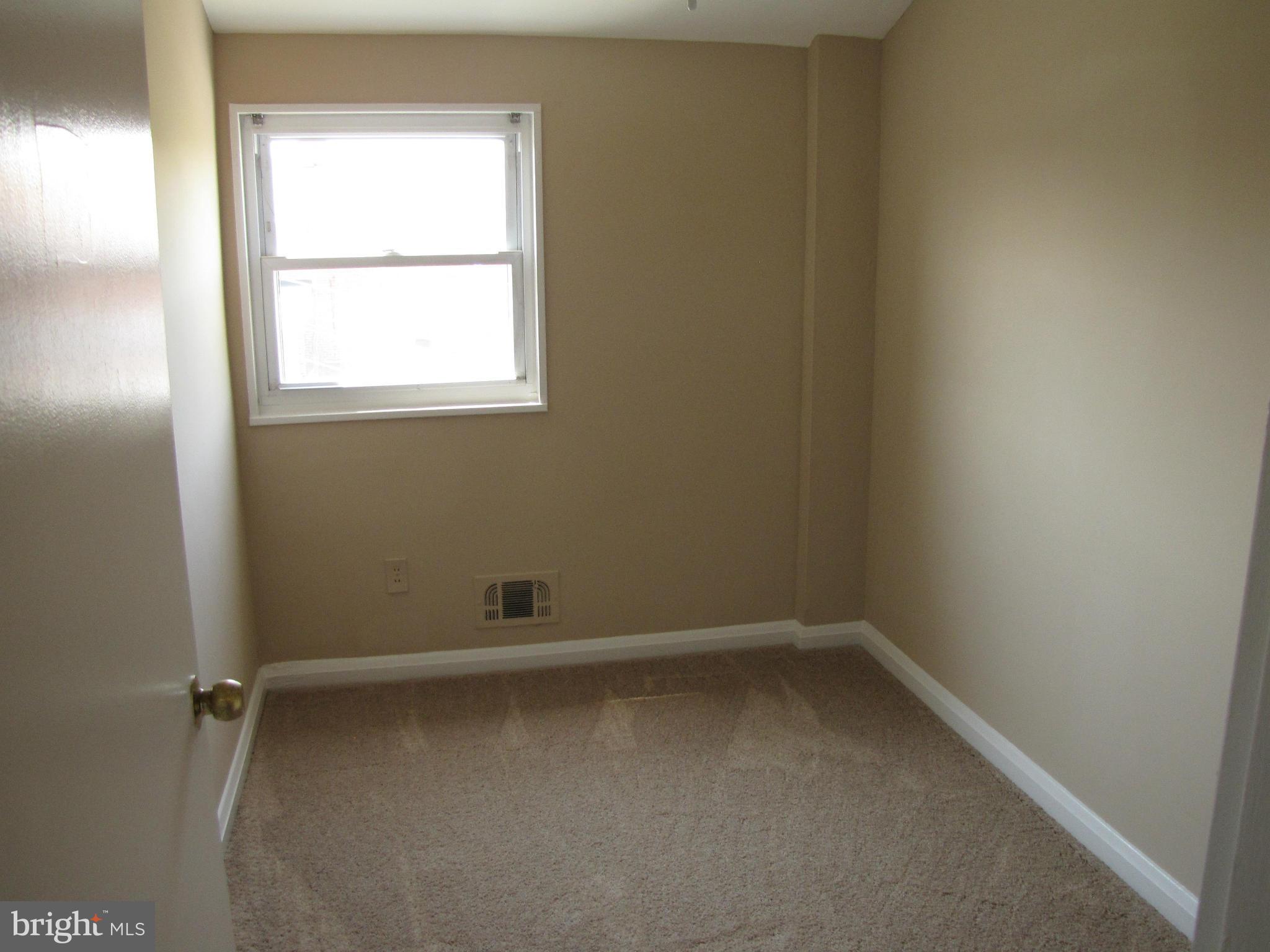 7900 Charlesmont Road Baltimore, MD 21222 - Photo 8 of 18 an empty room with a window