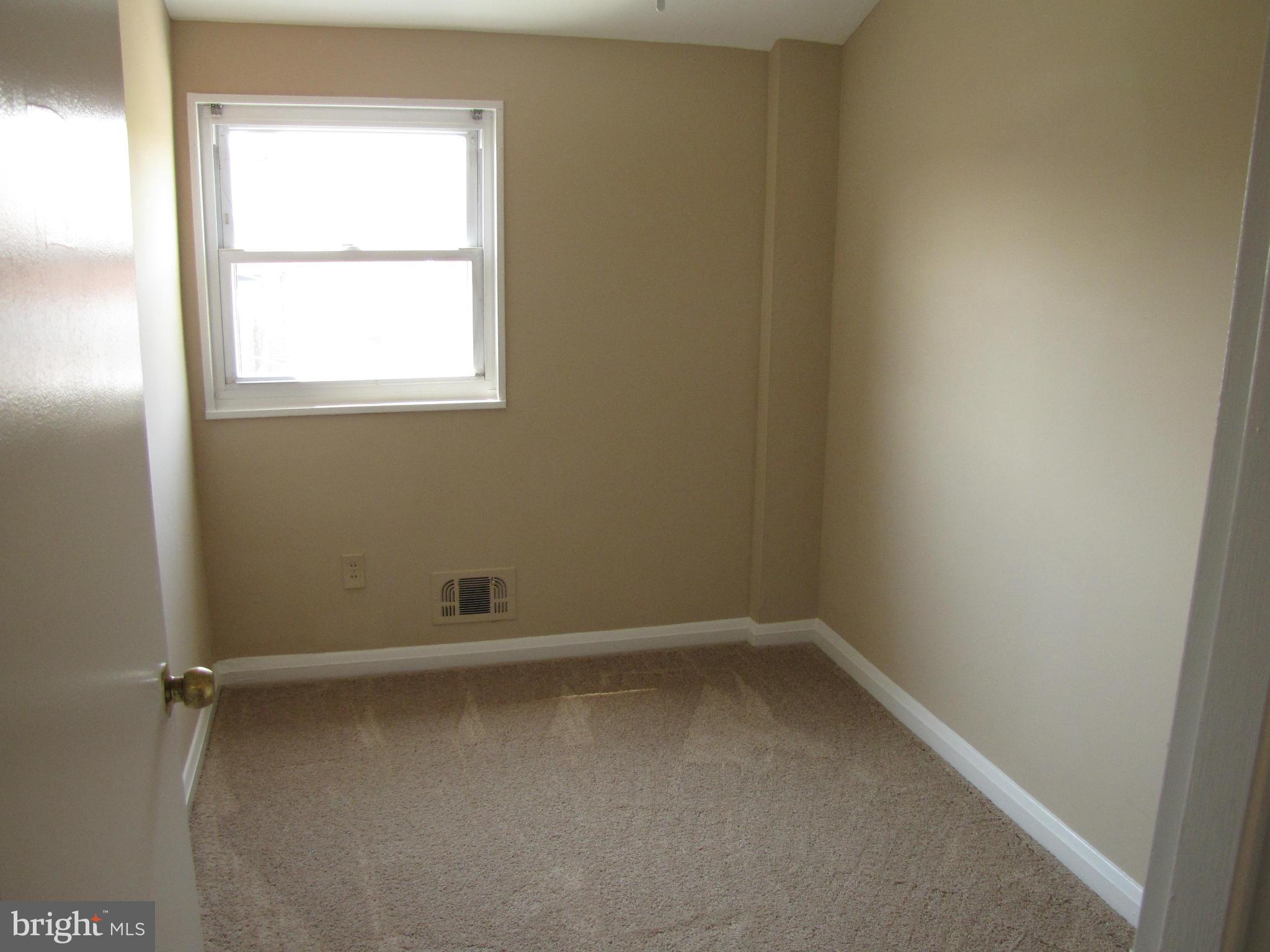 7900 Charlesmont Road Baltimore, MD 21222 - Photo 9 of 18 an empty room with a window
