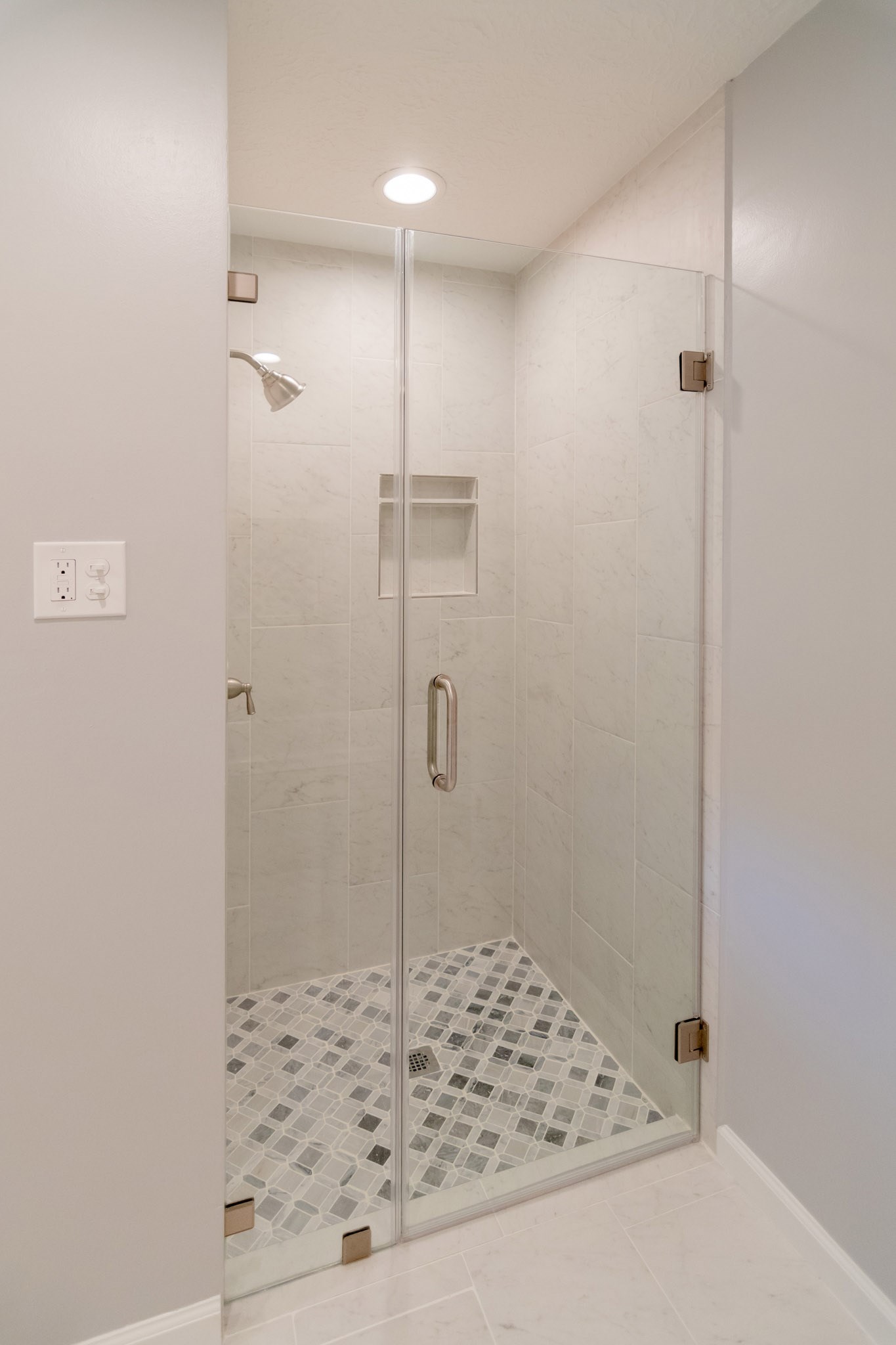 10 Coralvine Court Spring, TX 77380 - Photo 24 of 34 New modern walk-in shower has custom tile surround with decorative tile flooring and recessed shelf for bottles.