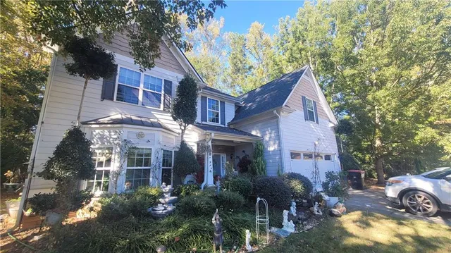 a view of a house with brick walls and plants