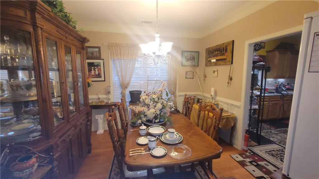 2182 Ann Lane Lithia Springs, GA 30122 - Photo 5 of 8 a view of a dining room with furniture and wooden floor