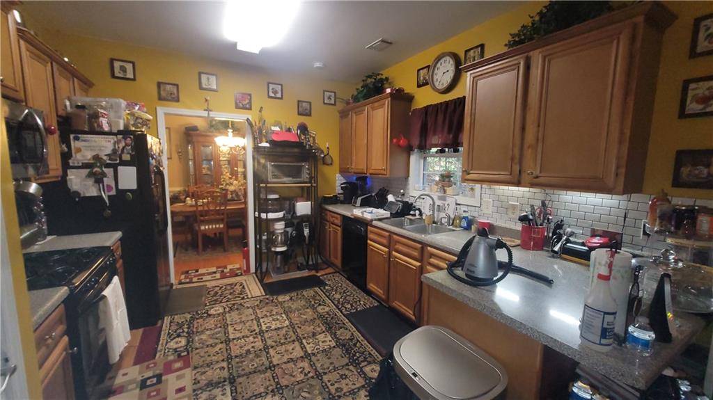 2182 Ann Lane Lithia Springs, GA 30122 - Photo 7 of 8 a kitchen with stainless steel appliances granite countertop a sink refrigerator and cabinets