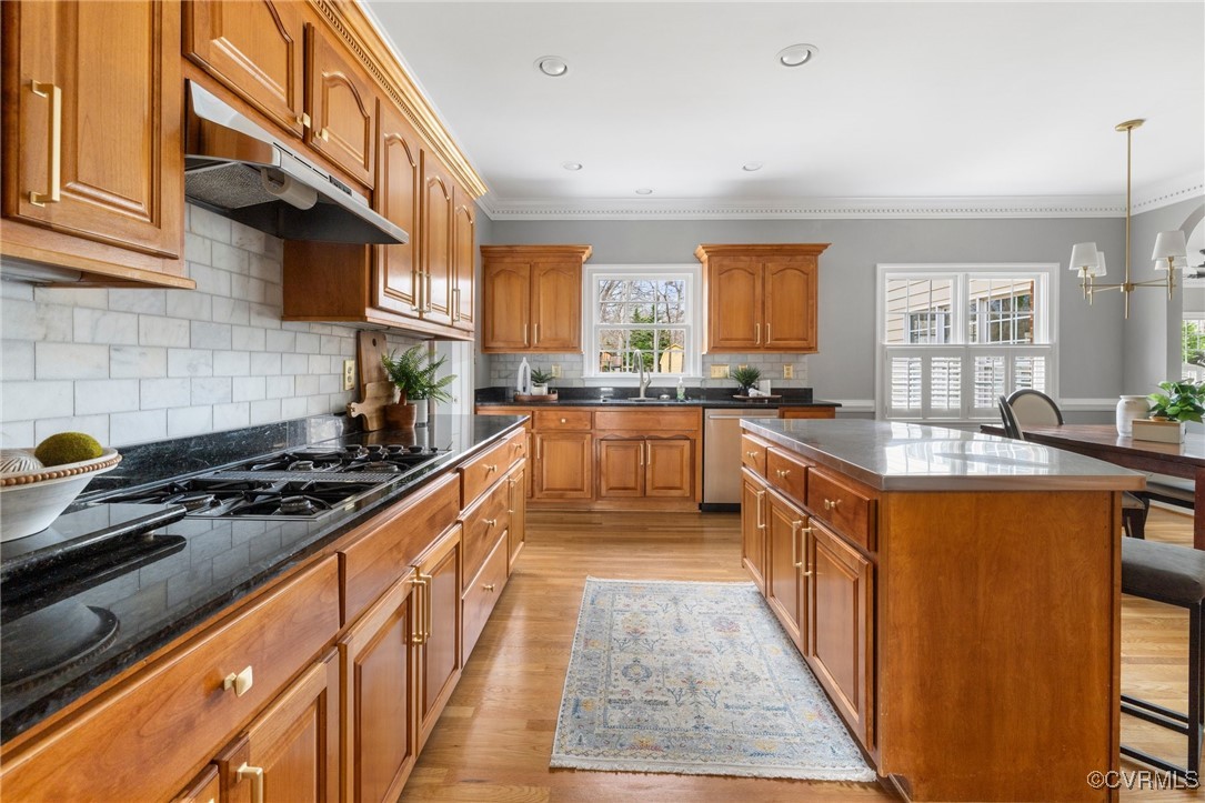 2311 Kings Lynn Road Midlothian, VA 23113 - Photo 11 of 50 a large kitchen with stainless steel appliances granite countertop a stove a sink dishwasher and cabinets