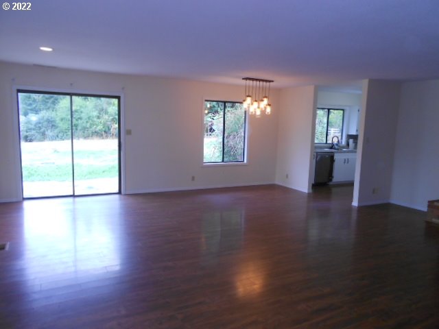 5355 Southwest River Road Hillsboro, OR 97123 - Photo 12 of 24 a view of an empty room with wooden floor and a window