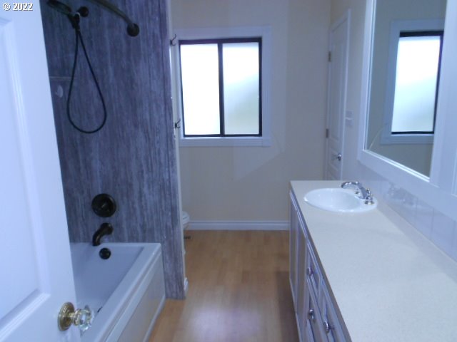 5355 Southwest River Road Hillsboro, OR 97123 - Photo 10 of 24 a bathroom with a sink a window and a shower