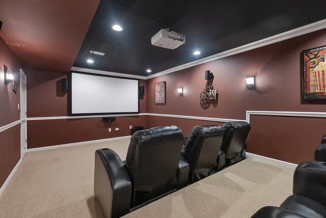 a media room with lots of chairs and a projector screen