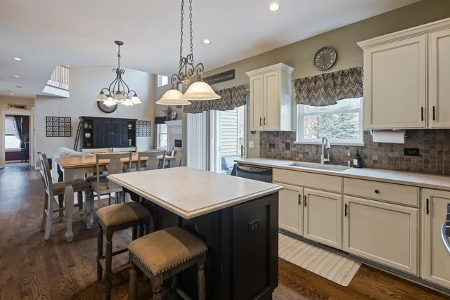 a large kitchen with a table and chairs