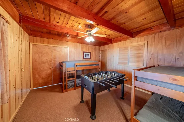 a bedroom with furniture and large windows
