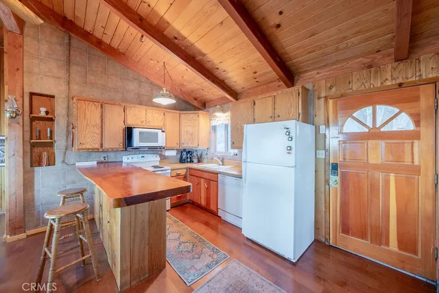 a kitchen with refrigerator and cabinets