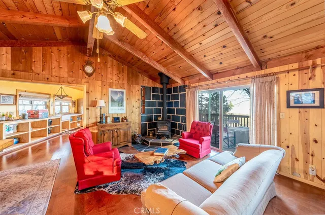 a living room with furniture and floor to ceiling windows