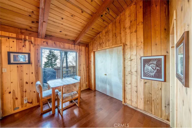 a view of a room with wooden floor and a window