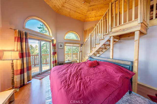 a bed sitting in a bedroom next to a window