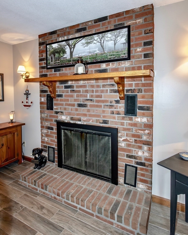 85 Lyman Road Chester, MA 01011 - Photo 11 of 34 a kitchen with stainless steel appliances wooden floor and a fireplace