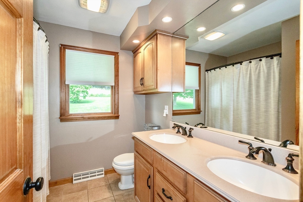 85 Lyman Road Chester, MA 01011 - Photo 19 of 34 a bathroom with a granite countertop sink toilet and a mirror