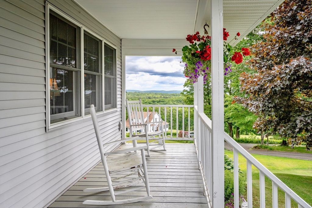 85 Lyman Road Chester, MA 01011 - Photo 3 of 34 a view of a balcony with wooden floor and iron fence