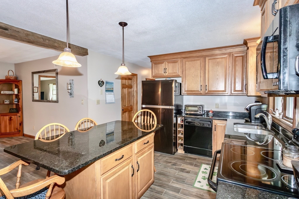 85 Lyman Road Chester, MA 01011 - Photo 7 of 34 a kitchen with granite countertop a stove a sink and a granite counter top