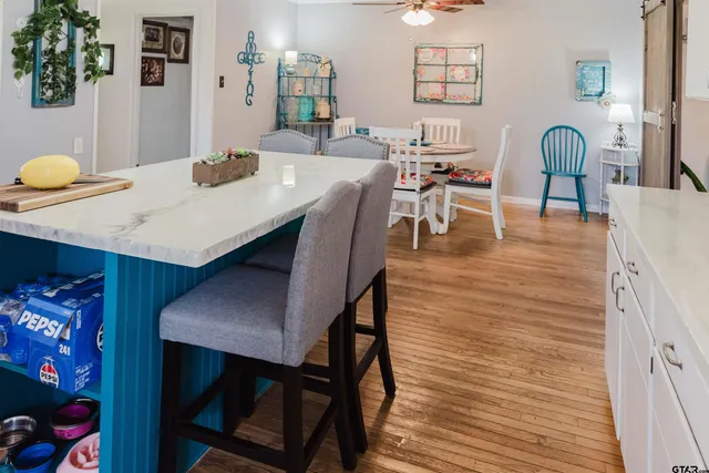 a dining room with furniture and wooden floor